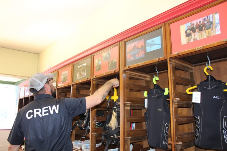 David Sowers show some of the equipment in his dive shop in Phoebus. (WYDaily/ Julia Marsigliano)