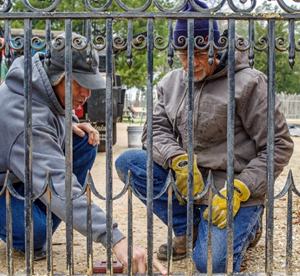Jonathan Appell (left) and Scott Hederer (right) examining damaged areas of the wrought iron gates. (WYDaily/Courtesy of Jamestown Rediscovery)