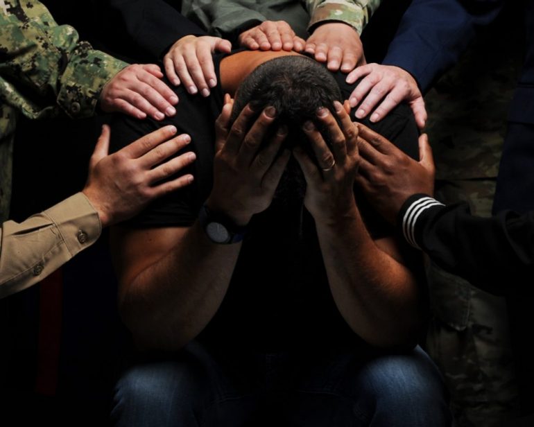 Jason Johnston, middle, poses for a photo at the Training Support Center Visual Information office located on Panzer Kaserne, Stuttgart, Germany on 12 July 2019. The U.S. Army photo was used for the Army Substance Abuse Program – Suicide Awareness Month. (WY Daily/ Courtesy Michele Wiencek)