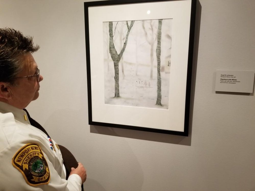 Lt. Kandyce Patrick-Gross looks at Angel LeVasseur's work "Playtime in the Winter" in the Beyond the Block exhibition at the Chrysler Museum of Art. (WYDaily/Courtesy Newport News Sheriff's Office)