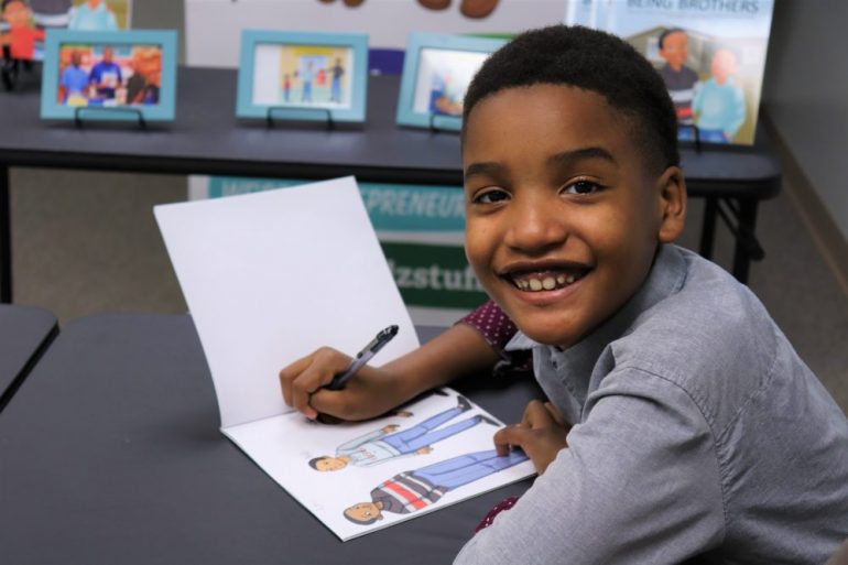 Christian Graves, a 10 year old author from Hampton, signs his third book Being Brothers before kicking off his 12-city bi-coastal tour. (Lucretia Cunningham/WYDaily)