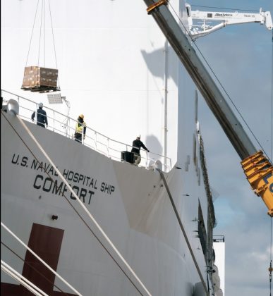 Supplies and personnel are loaded aboard the Military Sealift Command hospital ship USNS Comfort (T-AH 20) at Naval Station Norfolk, March 24, 2020. (Petty Officer 1st Class Joshua Sheppard)