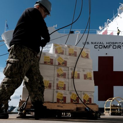 Supplies and personnel are loaded aboard the Military Sealift Command hospital ship USNS Comfort (T-AH 20) at Naval Station Norfolk, March 24, 2020. (Petty Officer 1st Class Joshua Sheppard)