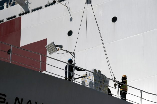 Supplies and personnel are loaded aboard the Military Sealift Command hospital ship USNS Comfort (T-AH 20) at Naval Station Norfolk, March 24, 2020. (Petty Officer 1st Class Joshua Sheppard)