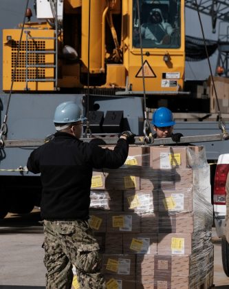 Supplies and personnel are loaded aboard the Military Sealift Command hospital ship USNS Comfort (T-AH 20) at Naval Station Norfolk, March 24, 2020. (Petty Officer 1st Class Joshua Sheppard)