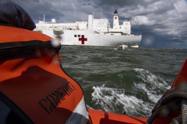 The hospital ship USNS Comfort (T-AH 20) anchors off the coast of Virginia as part of scheduled lifeboat training in accordance with US Coast Guard certification and watch keeping regulations before returning to Naval Station Norfolk. The ship and its embarked medical task force remain prepared for future tasking. The Navy, along with other U.S. Northern Command dedicated forces, remains engaged throughout the nation in support of the broader COVID-19 response. (U.S. Navy photo by Mass Communication Specialist 2nd Class Sara Eshleman)