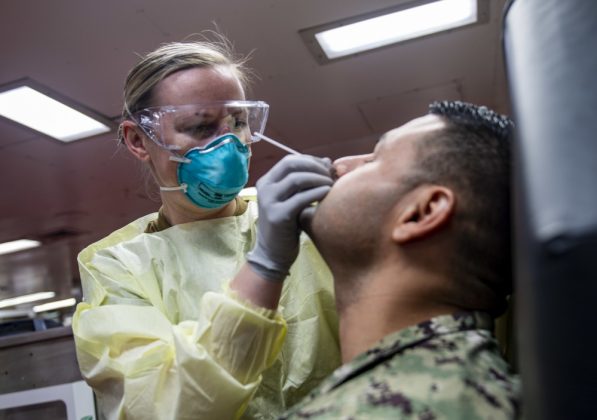 Lt. Mary Catherine Taylor collects a sample for a COVID-19 test aboard the hospital ship USNS Comfort (T-AH 20). All personnel aboard the ship are being tested as Comfort is transiting the Atlantic Ocean, returning to Naval Station Norfolk following its mission in New York City in support of the nation&rsquo;s COVID-19 response efforts. While in New York City, Comfort provided care for critical and non-critical patients without regard to their COVID-19 status. Comfort&rsquo;s operations in New York City were conducted in support of U.S. Northern Command&rsquo;s Defense Support of Civil Authorities as a response to the COVID-19 pandemic. (U.S. Navy photo by Mass Communication Specialist 1st Class Scott Bigley)