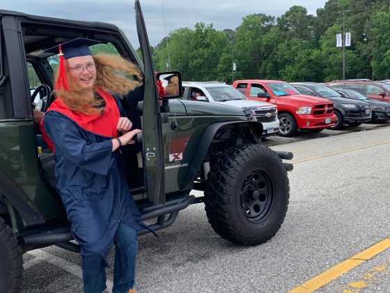Families waiting in a long line of cars to drop graduates off at a designated area where they would receive their diploma and walk across stage. (WYDaily/Alexa Doiron)