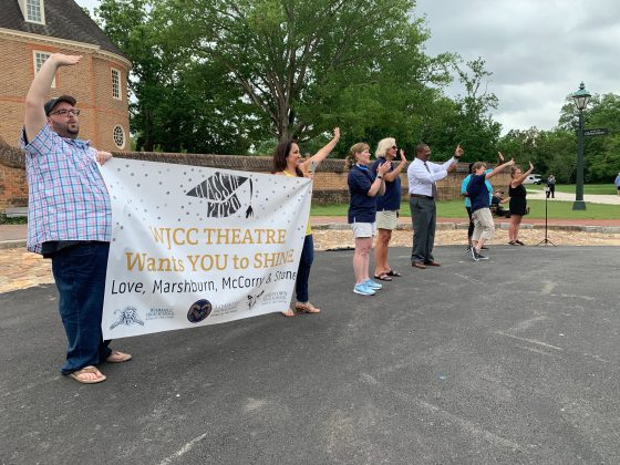 At the end of Duke of Gloucester Street, a group of teachers and staff from Jamestown High School waited to cheer on the students. (WYDaily/Alexa Doiron)