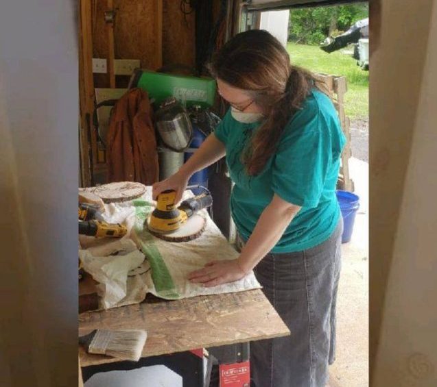 Mary Ardnt sanding down a piece of wood for one of her commissions. (WYDaily/ Courtesy of Mary Ardnt)
