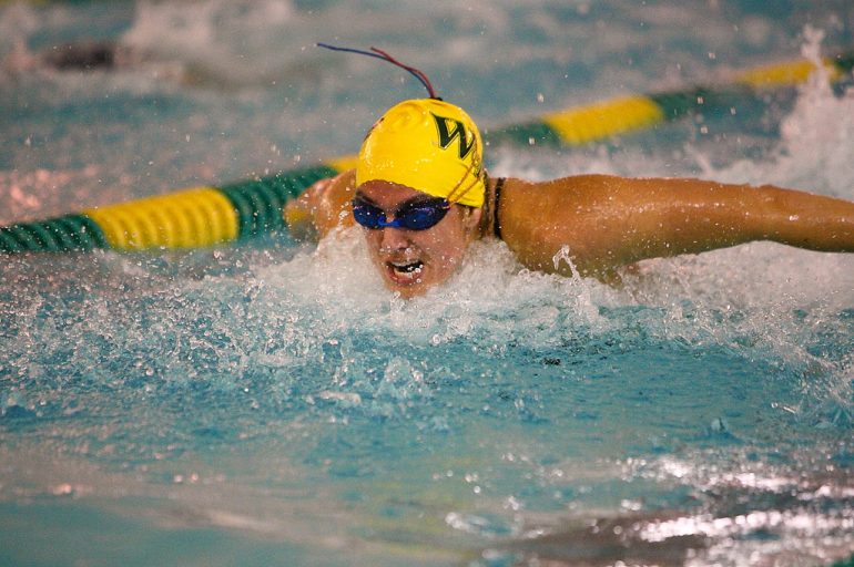A W&M swimmer competes in 2009 when the Tribe hosted the Towson University Tigers. (WYDaily file/Courtesy of W&M News)