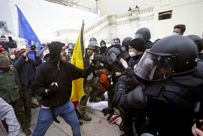 Trump supporters try to break through a police barrier, Wednesday, Jan. 6, 2021, at the Capitol in Washington. (WYDaily/ Courtesy of WTOP, AP Julio Cortez)