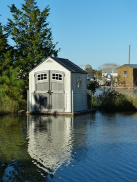 An amphibious shed rises with floodwaters in the VIMS Boat Basin. (VIMS/WYD)